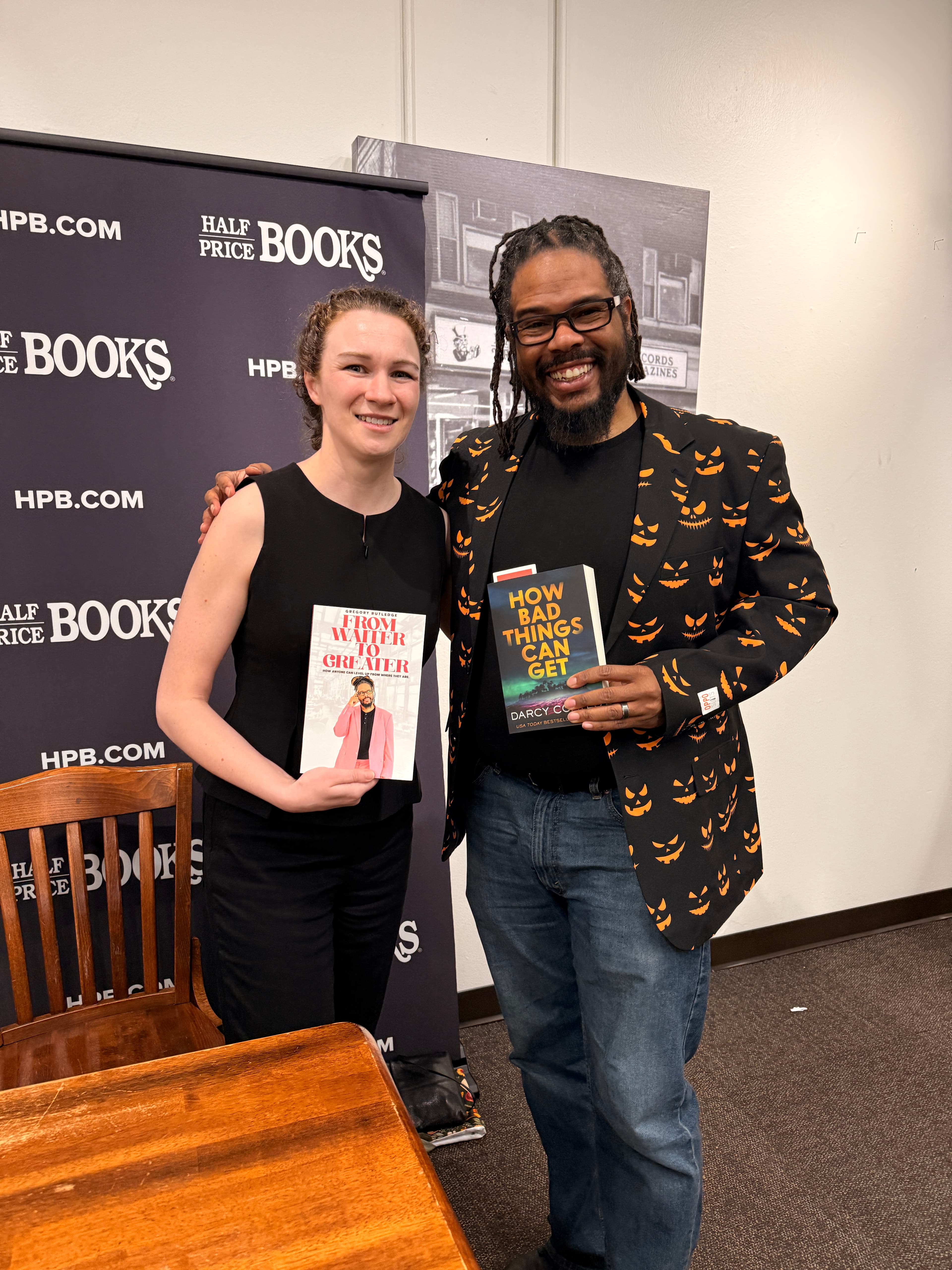 Gregory Rutledge trading books with author Darcy Coates at her book signing