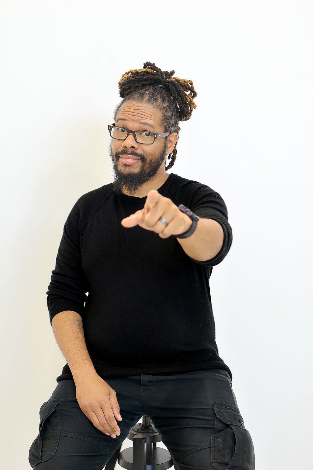 Gregory Rutledge pointing directly at the camera mid-conversation