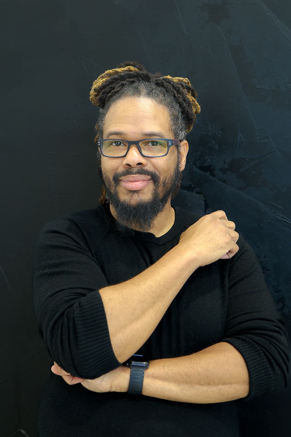 Gregory Rutledge, arms crossed, looking directly at the camera