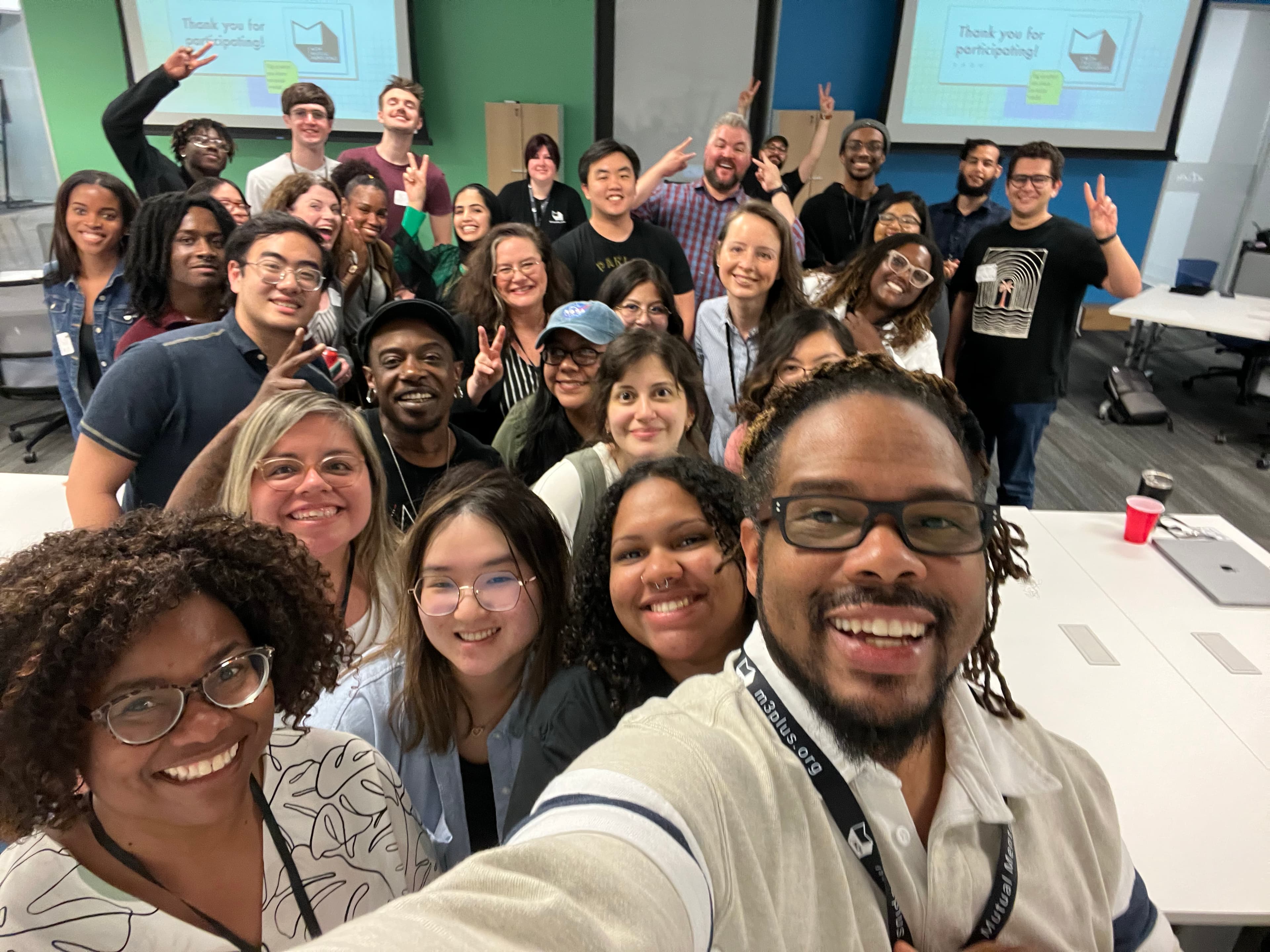 M3+ members crowding into a group selfie after a session